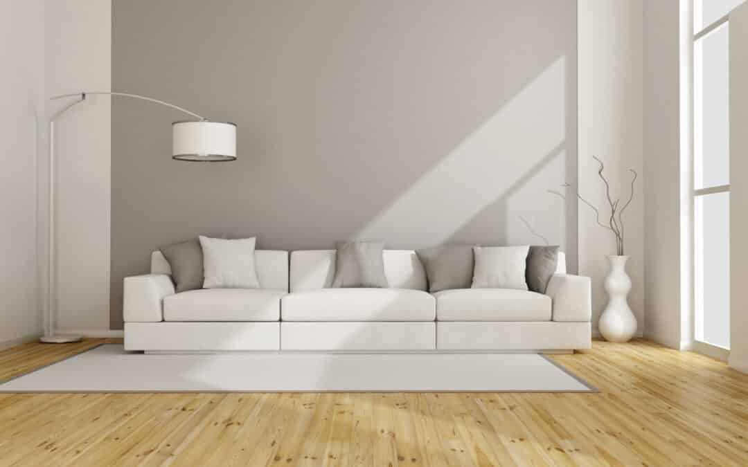 a gray room with a sofa and a floor lamp